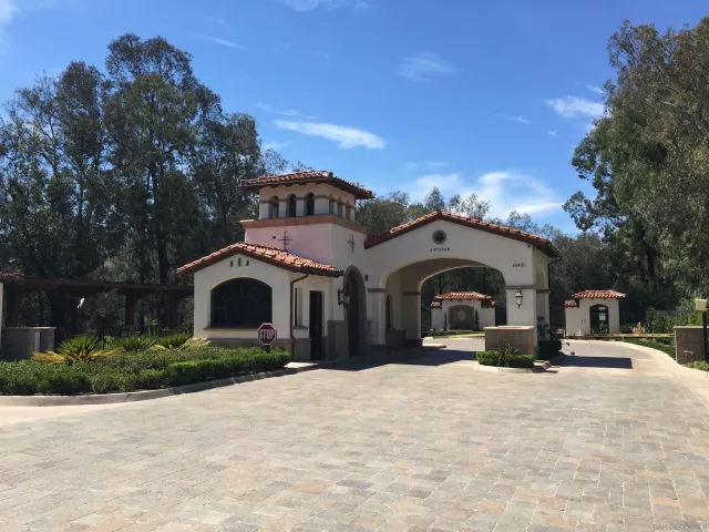 a view of a large pool with lawn chairs and a big yard