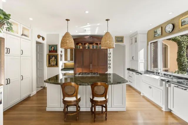 a open kitchen with stainless steel appliances granite countertop a stove and a view of living room with furniture