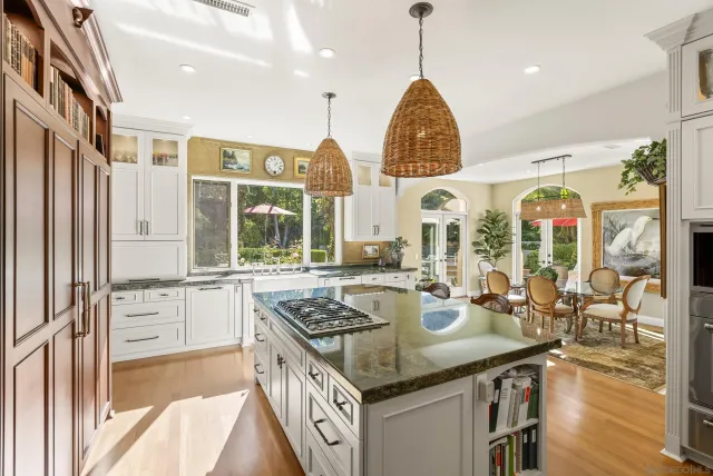 a dining room with furniture a chandelier and wooden floor