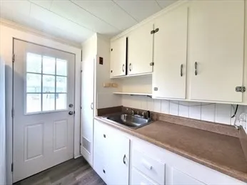 a kitchen with stainless steel appliances granite countertop a sink a stove and white cabinets