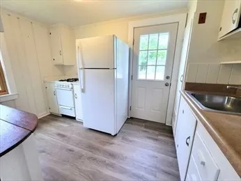 a kitchen with a refrigerator a stove a microwave and cabinets