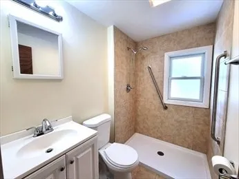 a bathroom with a sink toilet and shower