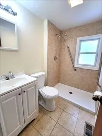 a bathroom with a sink toilet and shower