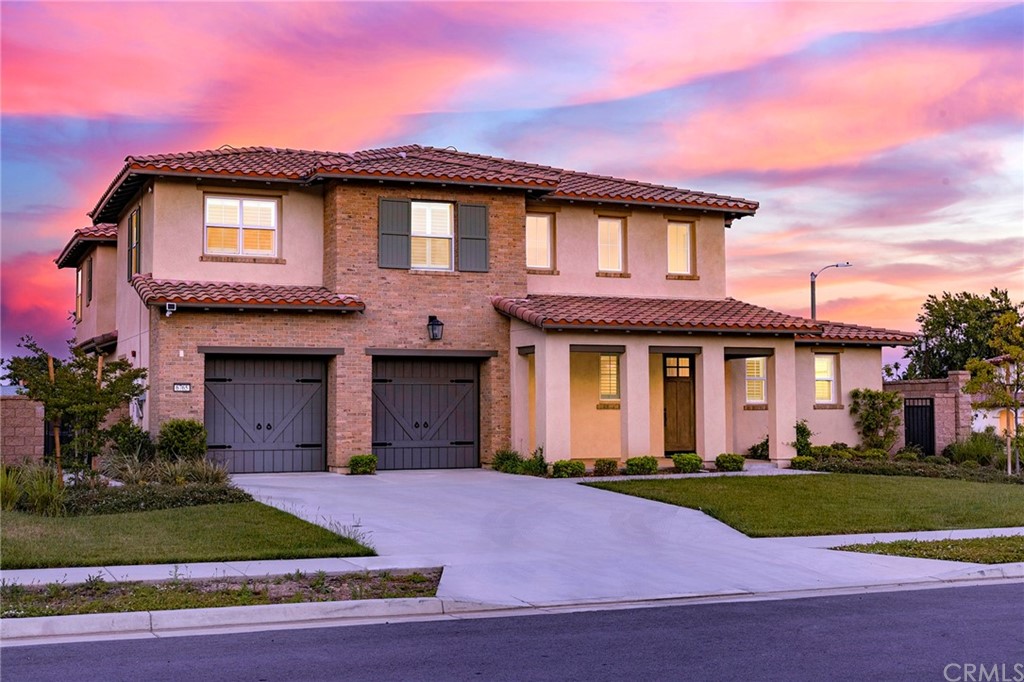 6765 Avana Place Rancho Cucamonga, CA 91739 - Photo 1 of 1 a front view of a house with a yard and garage
