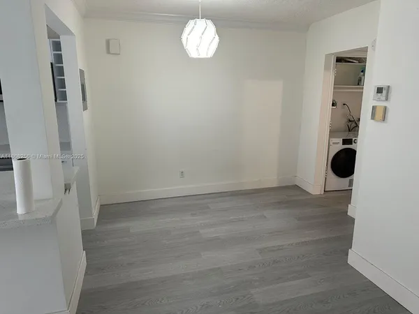a white toilet sitting next to a shower