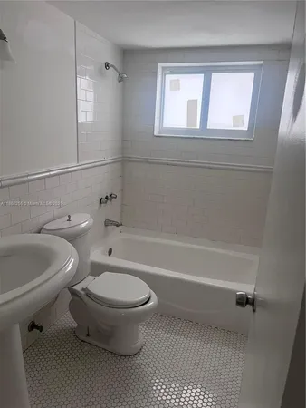 an empty room with wooden floor and cabinet