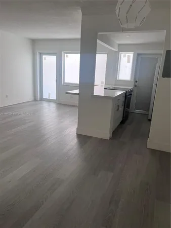 an empty room with wooden floor