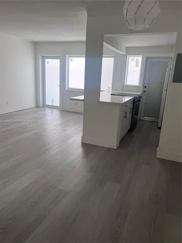 an empty room with wooden floor