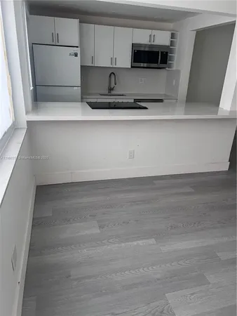a kitchen with stainless steel appliances a refrigerator and a stove