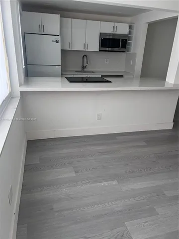 a kitchen with stainless steel appliances a refrigerator and a stove