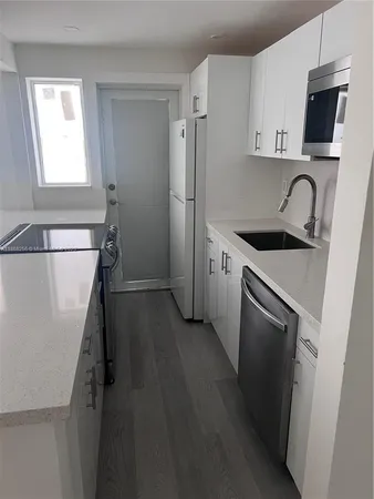 a kitchen with stainless steel appliances a refrigerator stove and sink