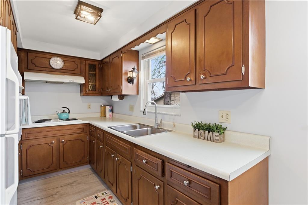 969 4th Street Baden, PA 15005 - Photo 12 of 28 a kitchen with stainless steel appliances granite countertop a sink a stove and cabinets