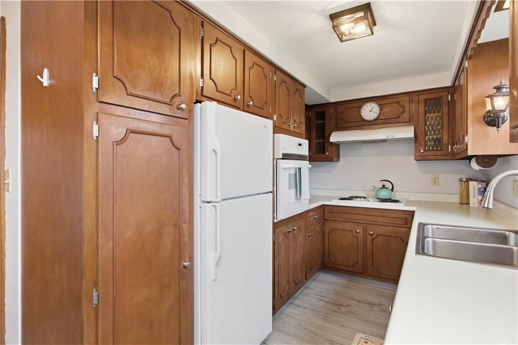 969 4th Street Baden, PA 15005 - Photo 13 of 28 a kitchen with cabinets and white appliances