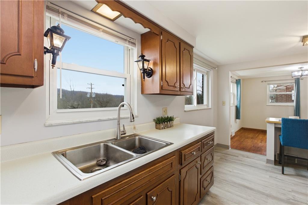 969 4th Street Baden, PA 15005 - Photo 14 of 28 a kitchen with a sink cabinets and wooden floor