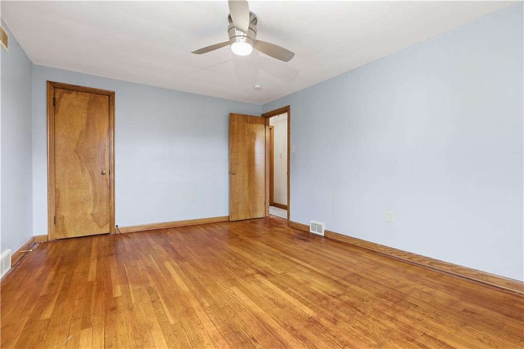 969 4th Street Baden, PA 15005 - Photo 16 of 28 a view of an empty room with wooden floor and a window