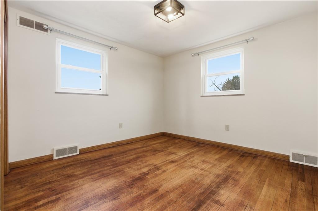 969 4th Street Baden, PA 15005 - Photo 17 of 28 a view of an empty room with wooden floor and a window