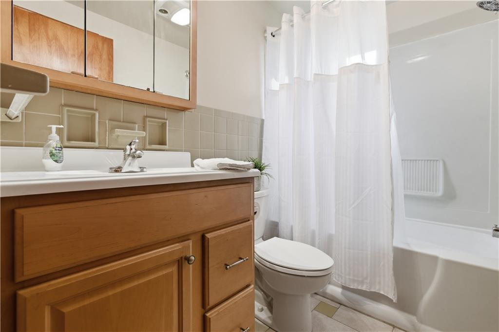 969 4th Street Baden, PA 15005 - Photo 19 of 28 a bathroom with a sink a toilet and shower