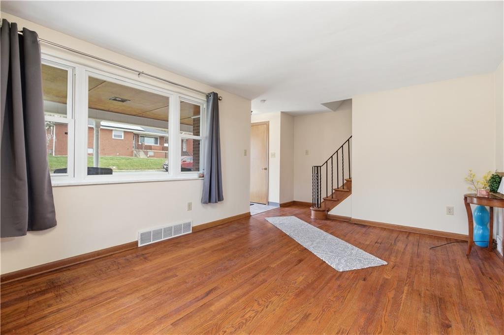 969 4th Street Baden, PA 15005 - Photo 5 of 28 a view of an empty room with wooden floor and a window