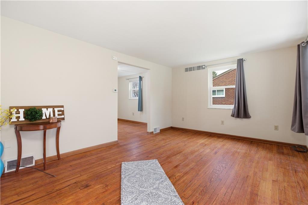 969 4th Street Baden, PA 15005 - Photo 7 of 28 an empty room with wooden floor and windows