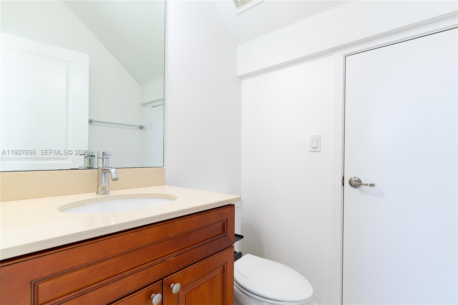 4638 Northwest 59th Street Tamarac, FL 33319 - Photo 11 of 34 a bathroom with a sink a toilet a mirror and shower