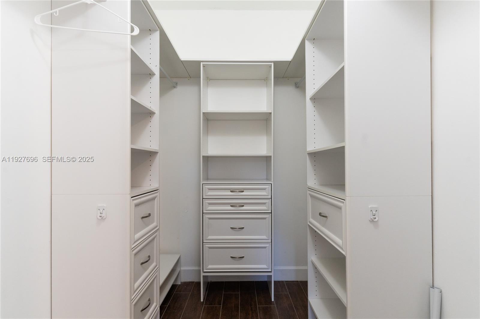 4638 Northwest 59th Street Tamarac, FL 33319 - Photo 17 of 34 a view of walk in closet with empty racks