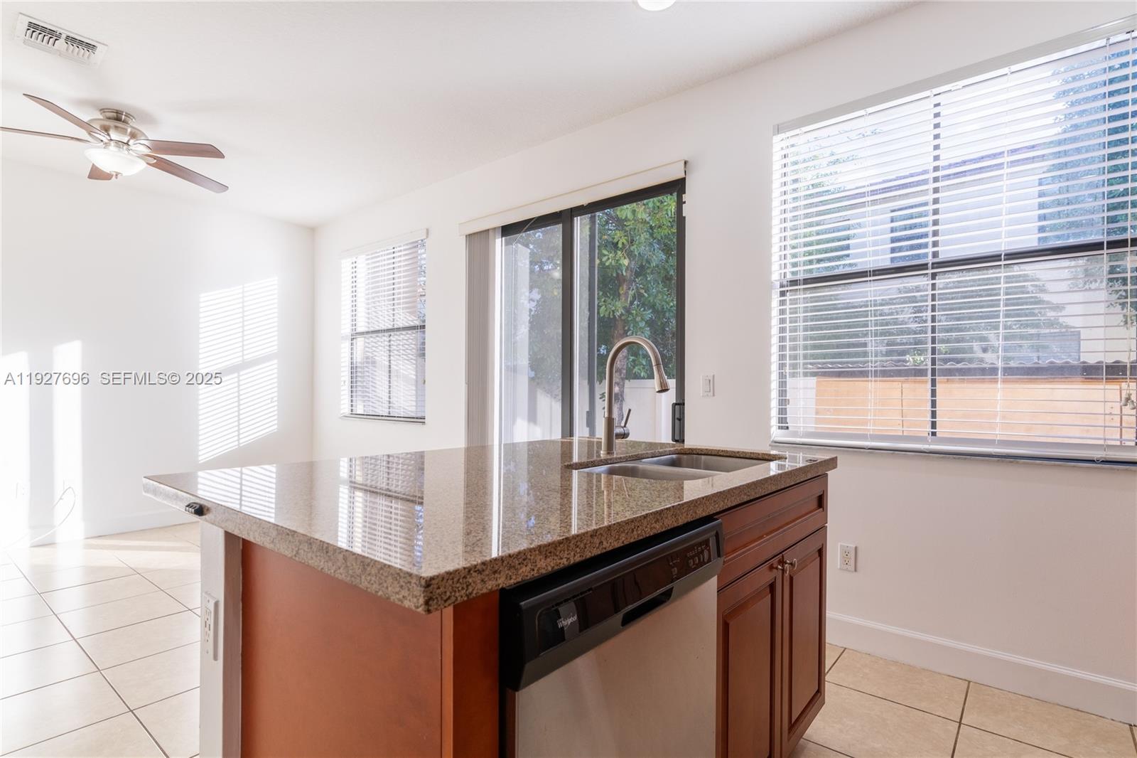 4638 Northwest 59th Street Tamarac, FL 33319 - Photo 5 of 34 a kitchen with kitchen island a large counter top space and a sink