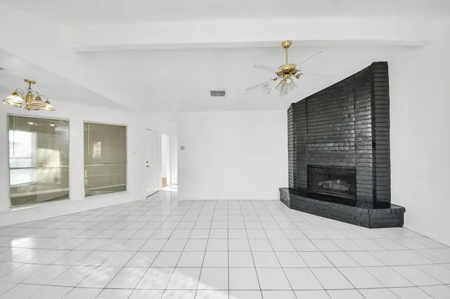 a view of an empty room with a fireplace