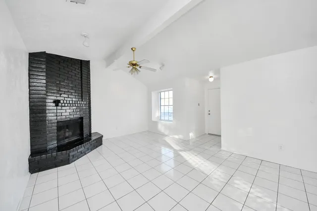 a view of an empty room with a fireplace