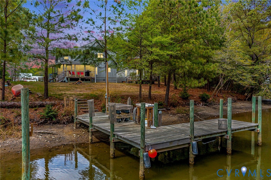 The property features a private wooden dock with a