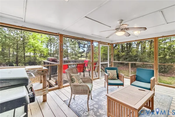 a view of a wooden deck with a yard and wooden fence