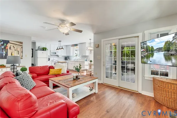 a living room with furniture and painting on the wall