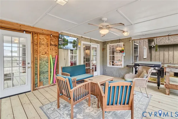 a view of a balcony with wooden floor and outdoor seating