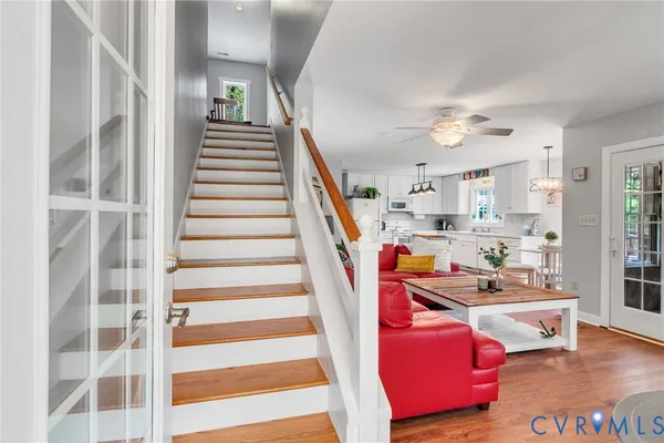 a view of a porch with wooden floor and outdoor seating