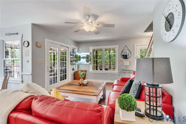 a kitchen with stainless steel appliances granite countertop a stove a refrigerator a sink dishwasher a dining table and chairs with wooden floor