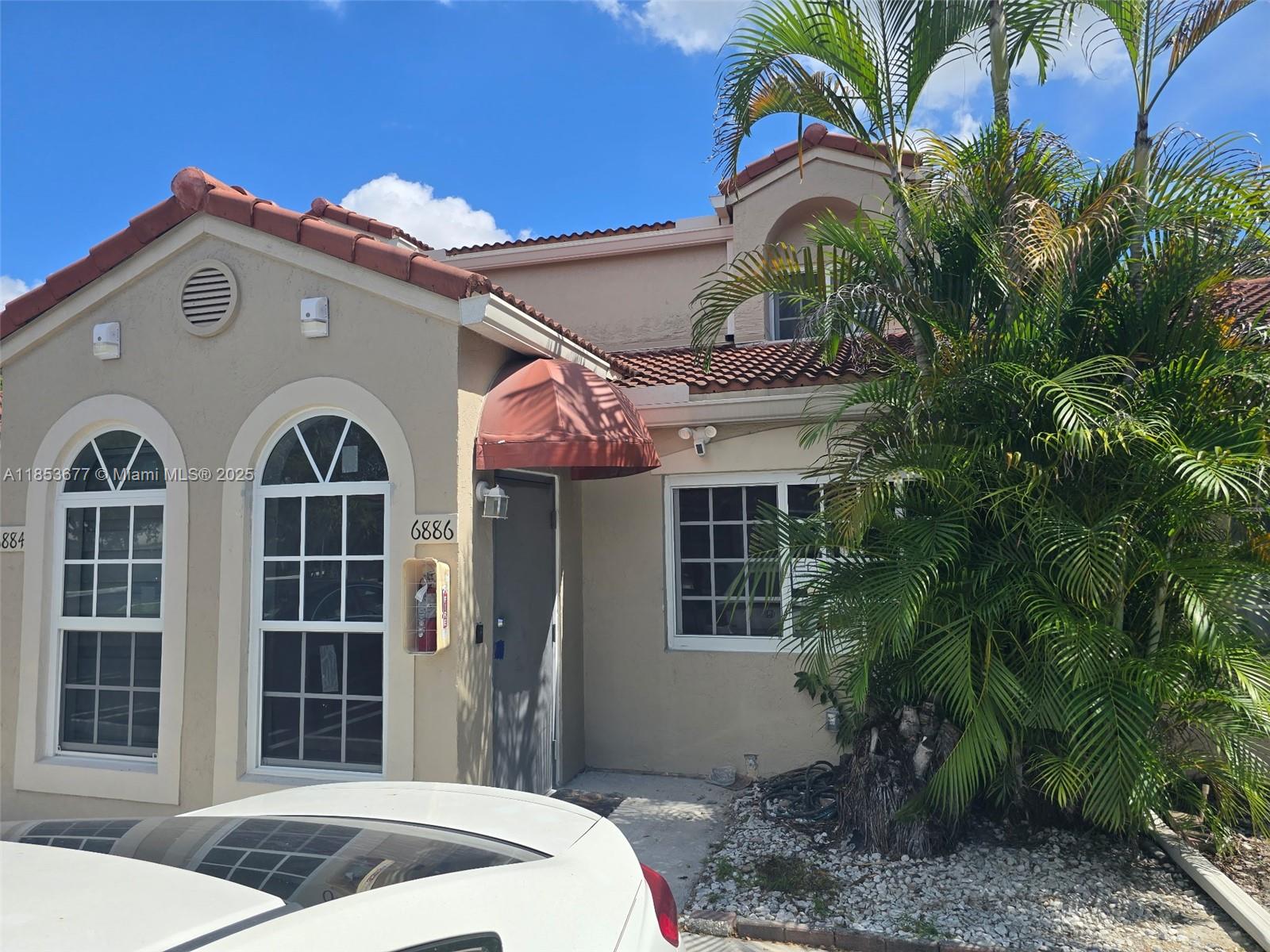 a front view of a house with garden