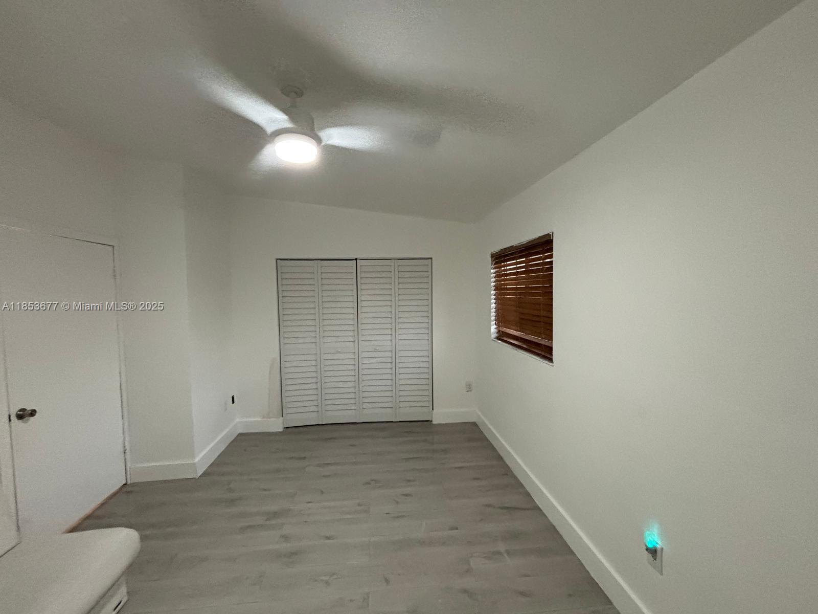 6886 Northwest 166th Terrace, Unit 1004 Miami Lakes, FL 33014 - Photo 13 of 27 wooden floor in an empty room