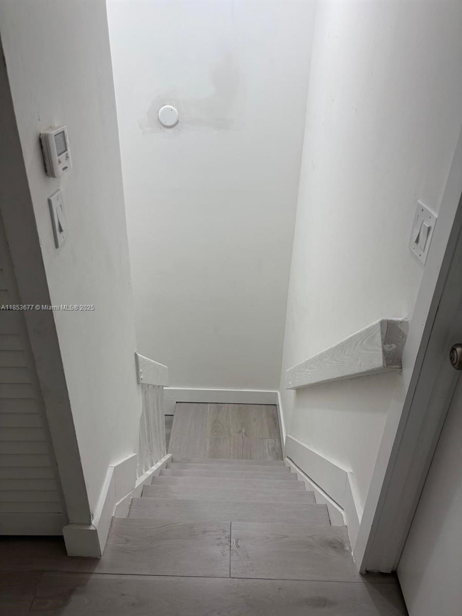 6886 Northwest 166th Terrace, Unit 1004 Miami Lakes, FL 33014 - Photo 16 of 27 a view of an empty walk in closet