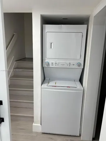 a living room with a flat screen tv and a wall painting