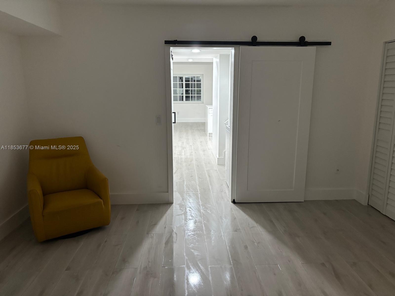 6886 Northwest 166th Terrace, Unit 1004 Miami Lakes, FL 33014 - Photo 26 of 27 a view of livingroom with furniture and wooden floor