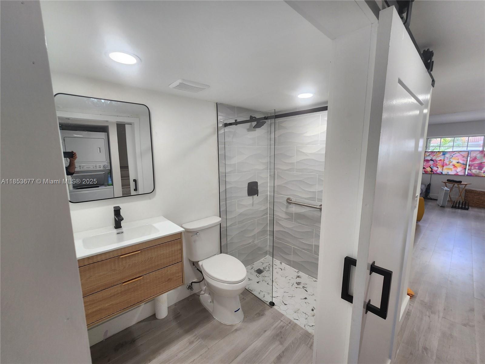 6886 Northwest 166th Terrace, Unit 1004 Miami Lakes, FL 33014 - Photo 4 of 27 a bathroom with a sink a toilet and shower