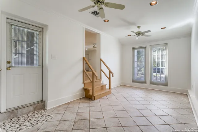 a view of an entryway with a chandelier fan