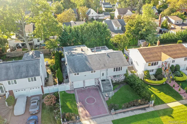 an aerial view of a house with yard swimming pool and outdoor seating