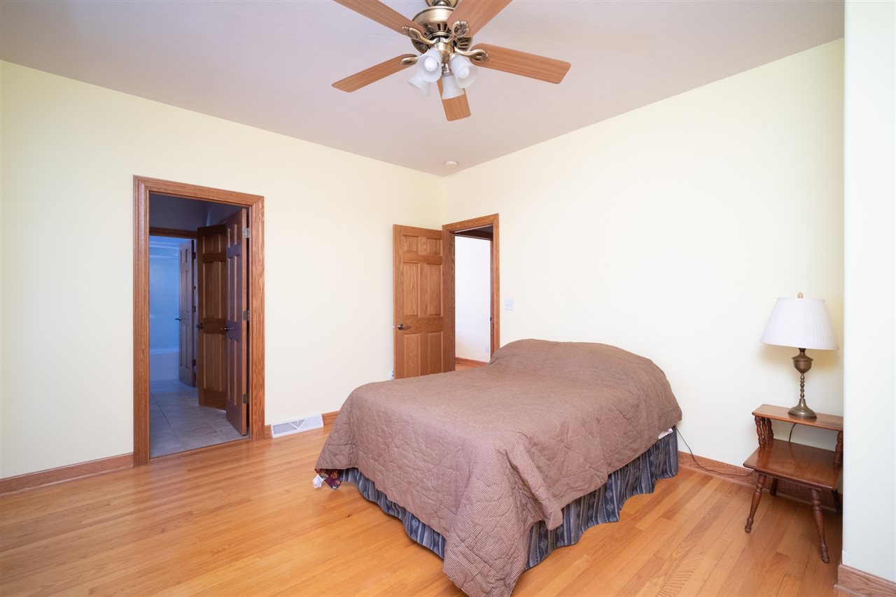 2485 Malmaison Road Belvidere, IL 61008 - Photo 23 of 33 a bedroom with a bed and a chandelier