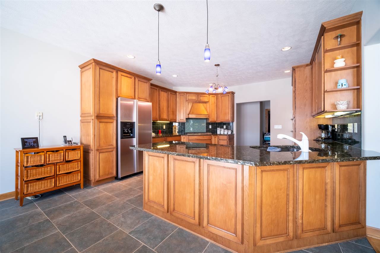 2485 Malmaison Road Belvidere, IL 61008 - Photo 8 of 33 a view of a kitchen with kitchen island granite countertop wooden cabinets and a stainless steel appliances