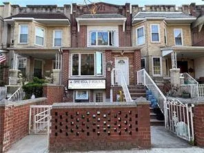 a front view of a house with large windows
