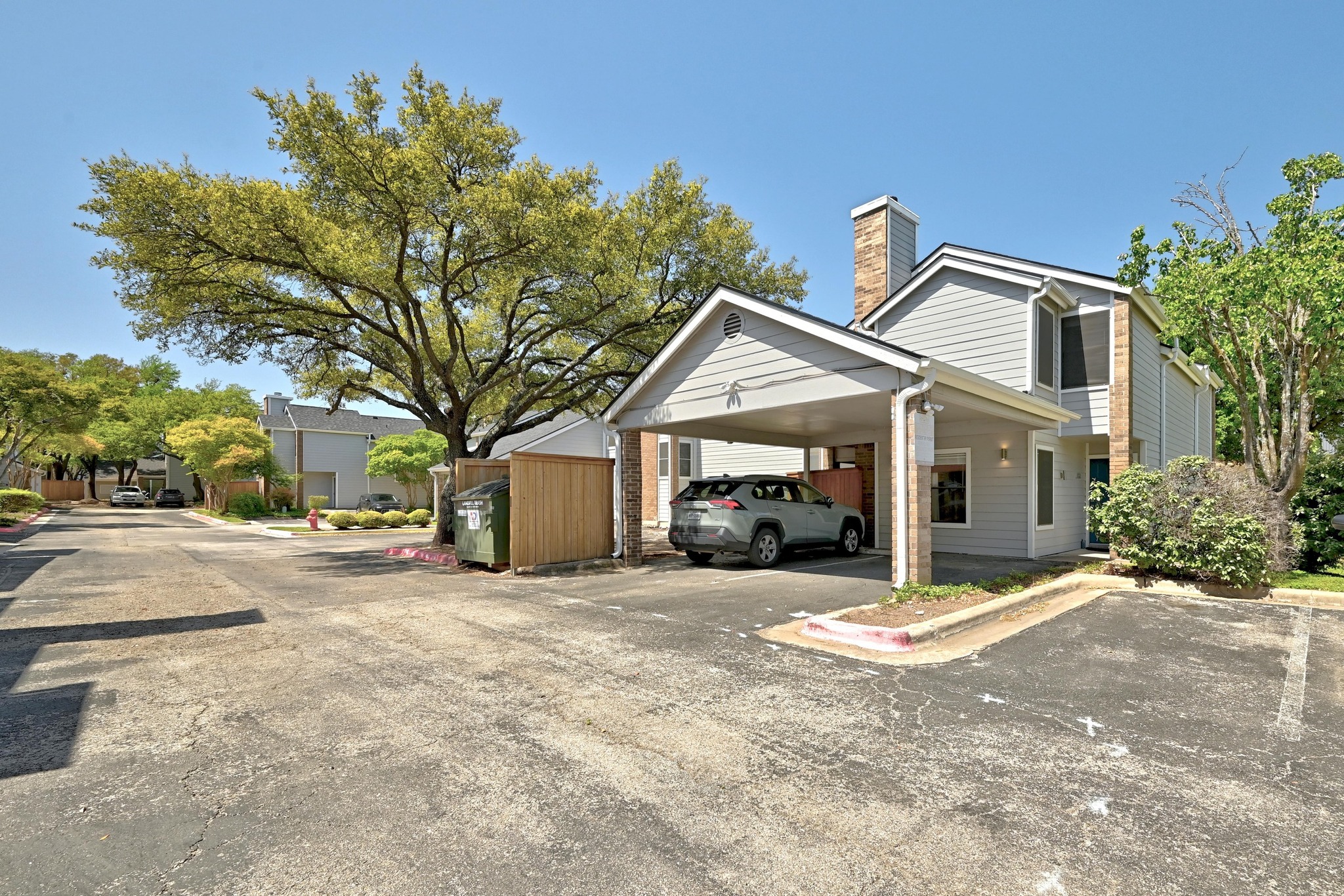 7635 Guadalupe Street, Unit 1002 Austin, TX 78752 - Photo 2 of 27 a view of a house with a yard and large tree