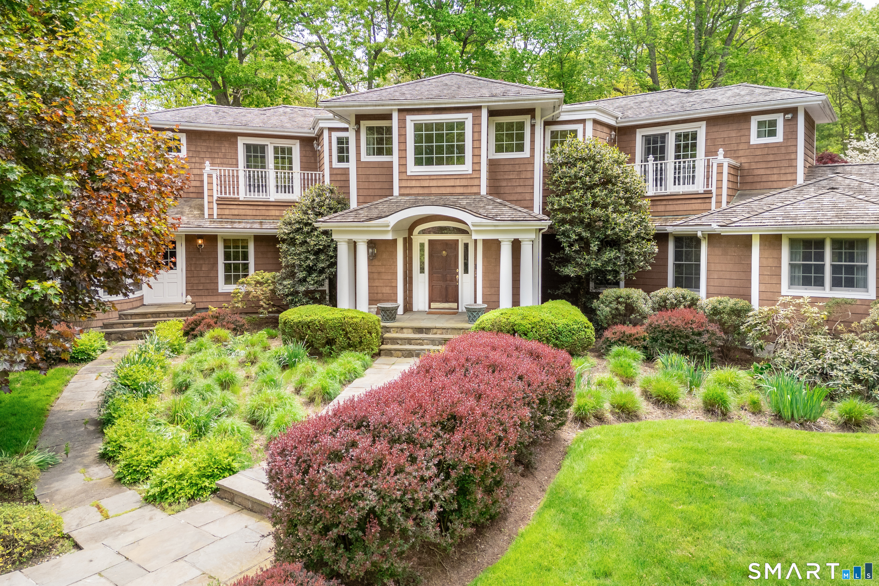 41 Lake Wind Road New Canaan, CT 06840 - Photo 1 of 38 a front view of a house with garden