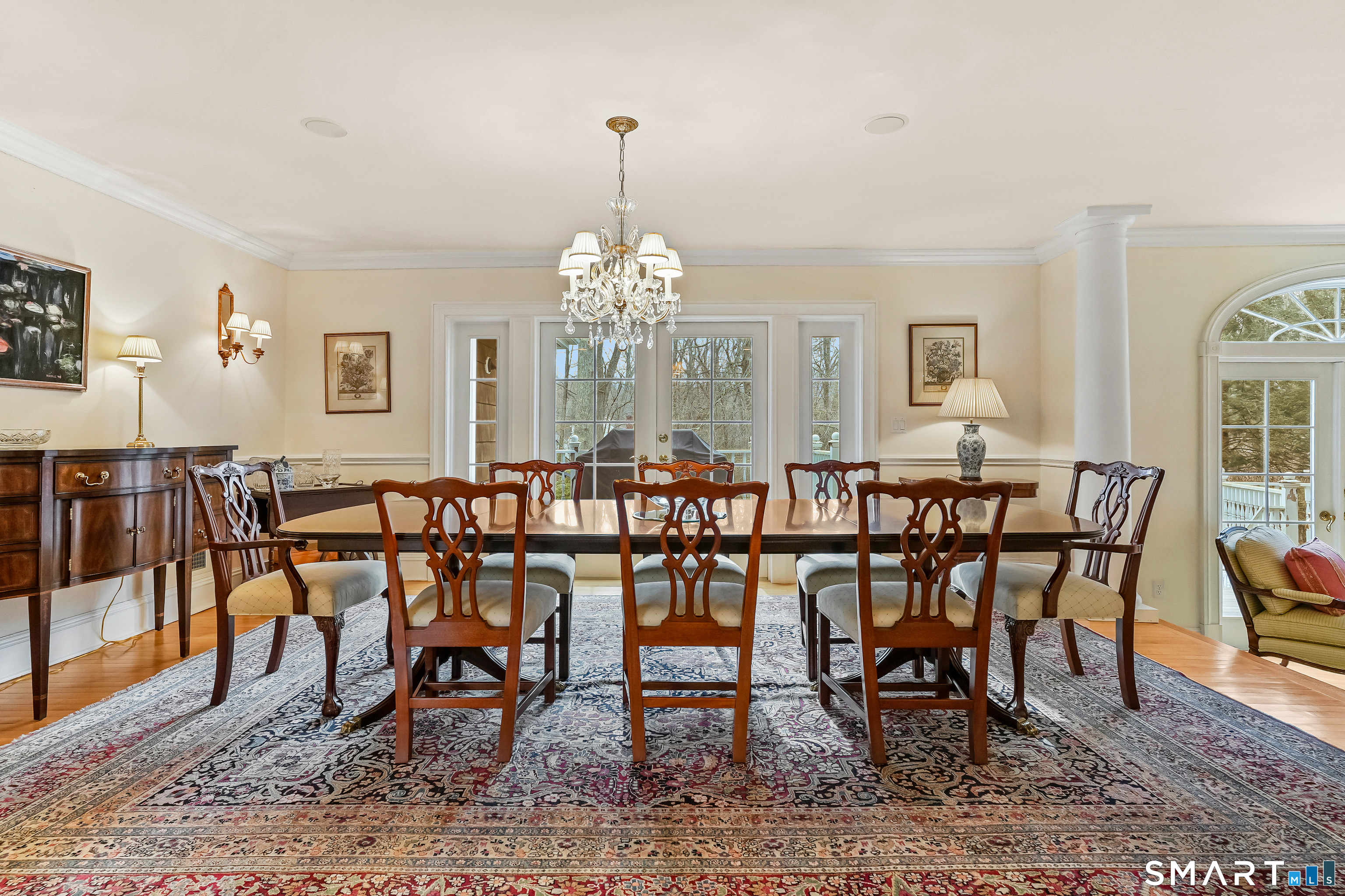 41 Lake Wind Road New Canaan, CT 06840 - Photo 11 of 38 a view of a dining room and livingroom with furniture wooden floor and a chandelier