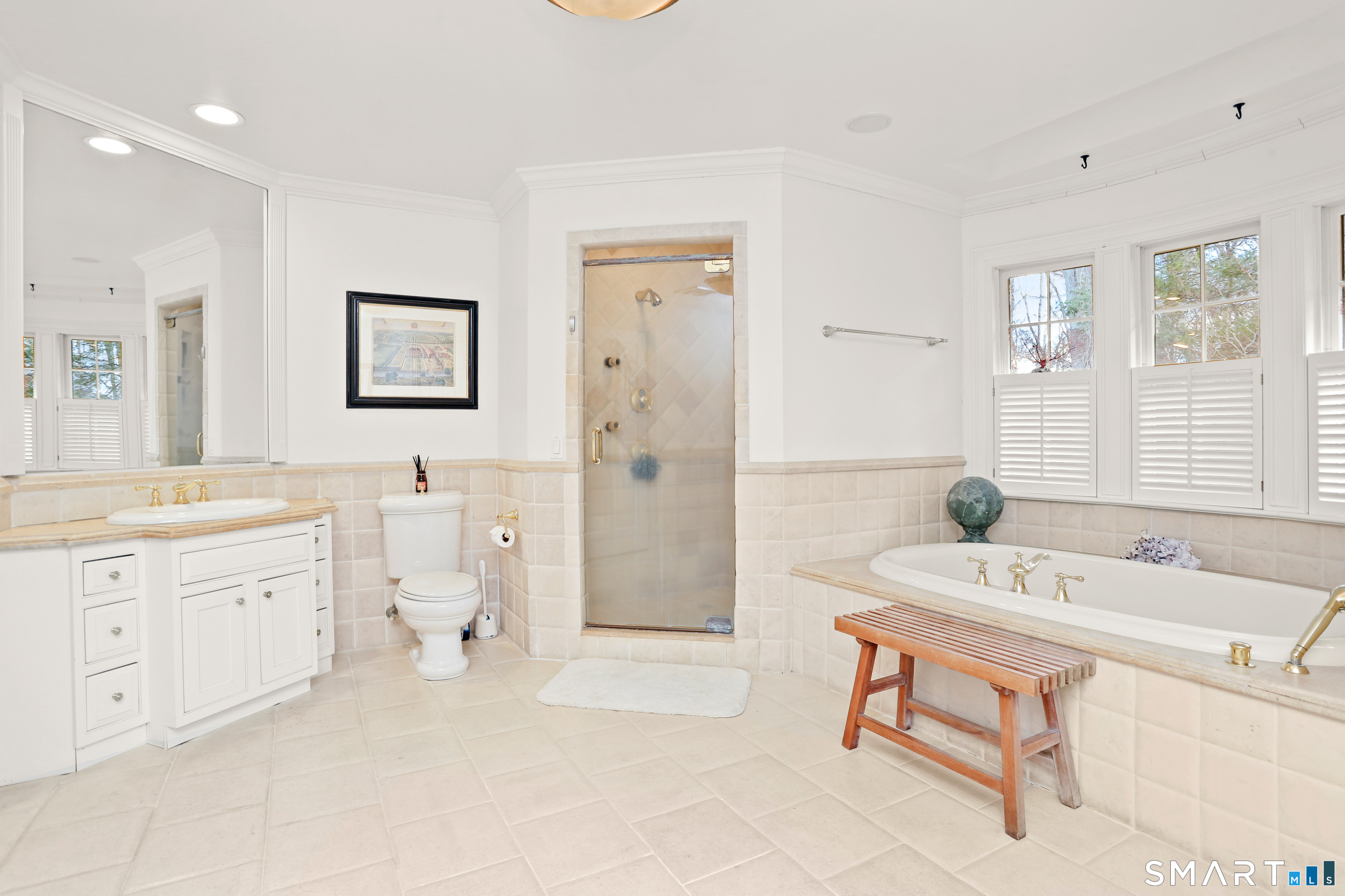 41 Lake Wind Road New Canaan, CT 06840 - Photo 16 of 38 a spacious bathroom with a tub sink and mirror