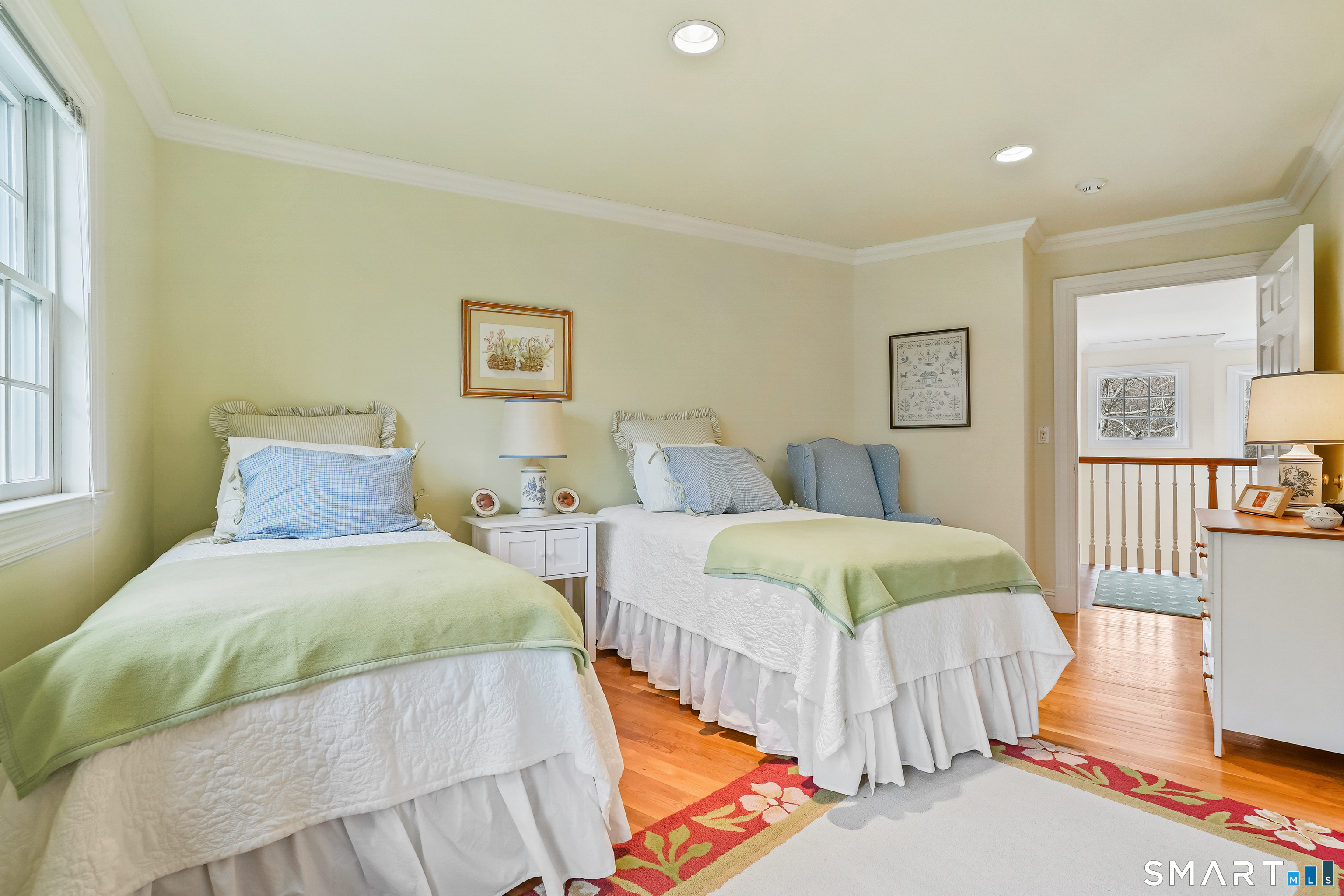 41 Lake Wind Road New Canaan, CT 06840 - Photo 18 of 38 a spacious bedroom with two beds and painting on the wall